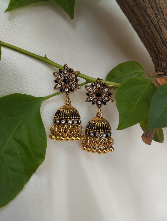 Black & White Stone Antique Gold Plated Jhumka EarringsDesign: Floral star stud + textured dome with layered ghungroos
